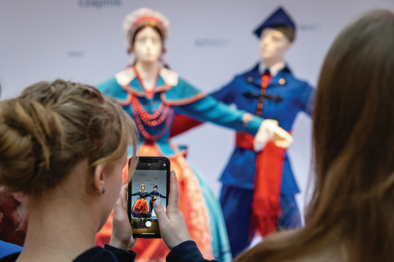 Visitors to the Centre for Polish Folklore in Karolin take a photograph of a costume on display