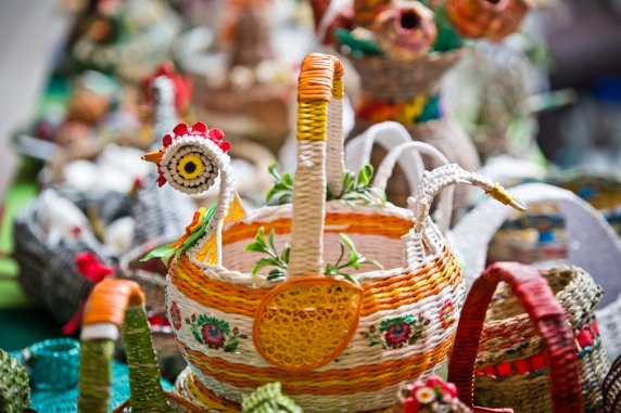 Handmade Easter decorations, with a woven basket in the shape of a cockrel in the foreground