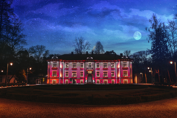 Karolin Palace on a moonlit night, lit up in red